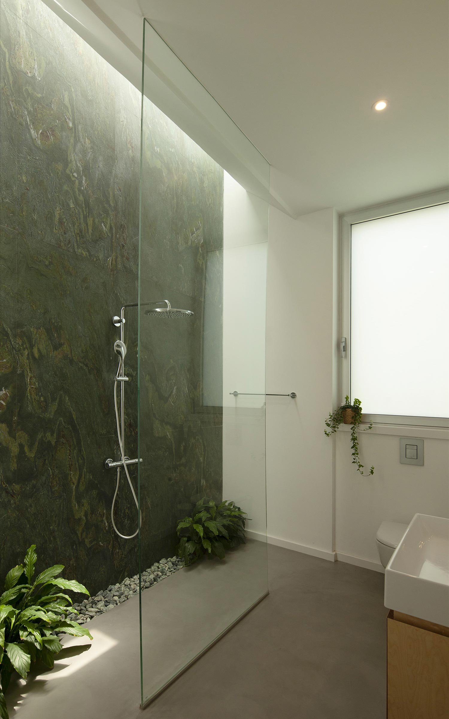 Walk in shower with Green Verde Fantastico marble cladding