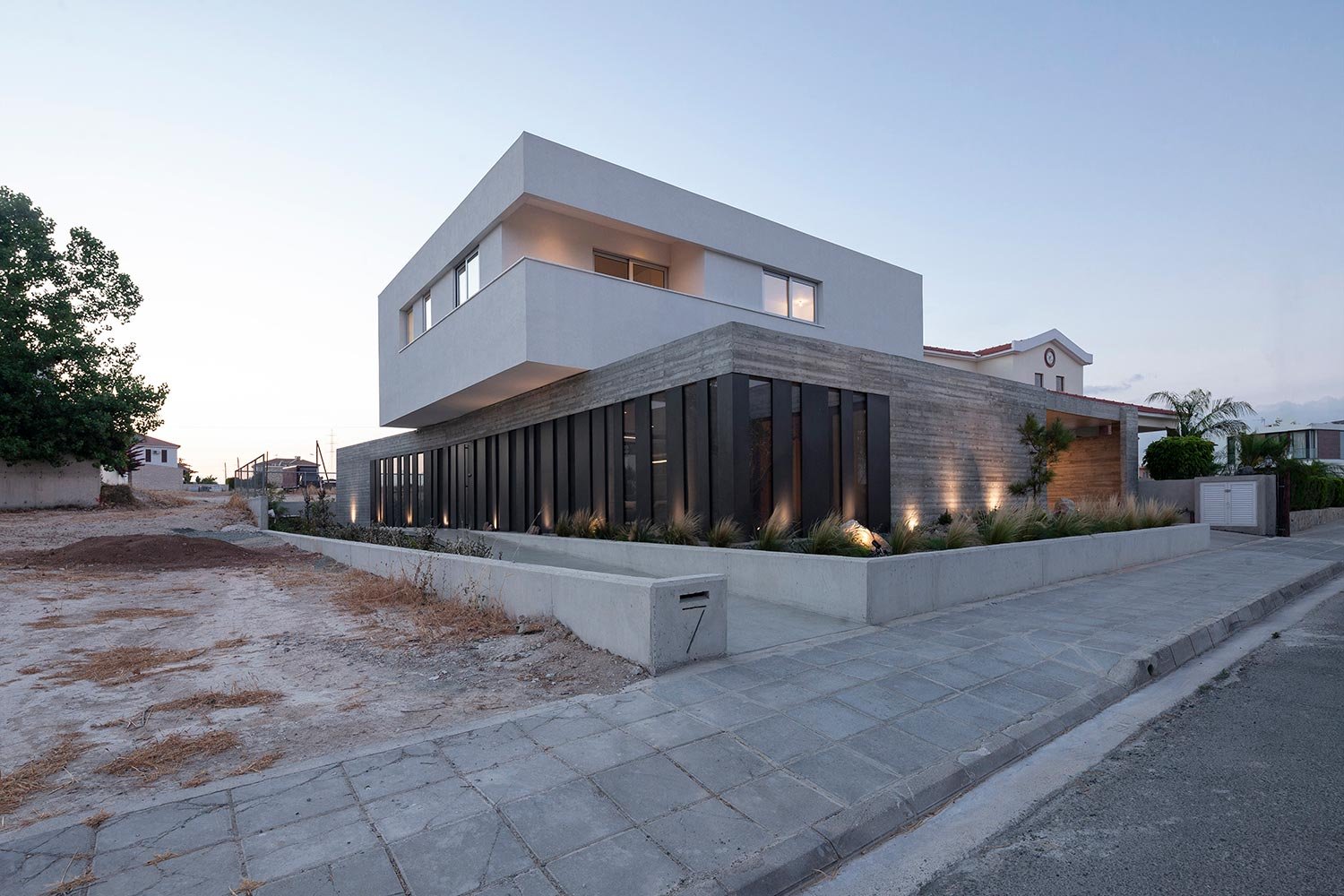 Modern house with board form concrete walls and aluminium cladding